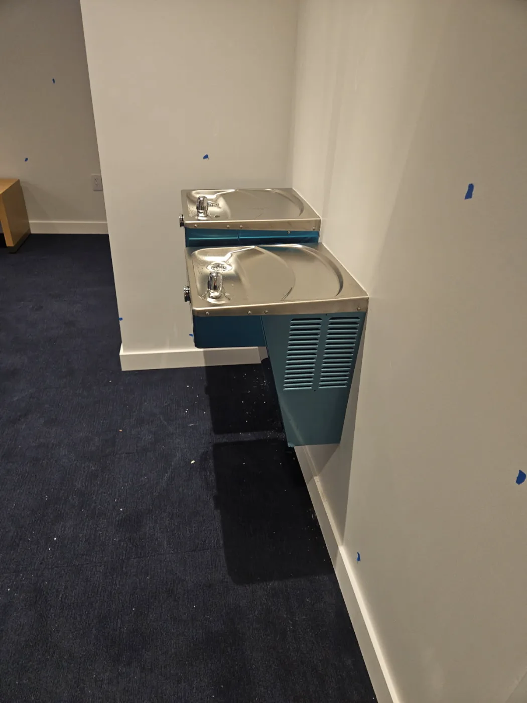 Bi-level stainless drinking fountains installed in an office corridor