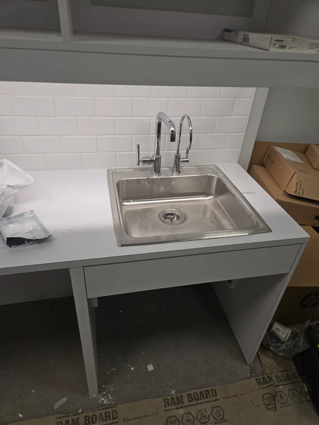 Drop-in stainless sink with faucet and filtered water tap installed