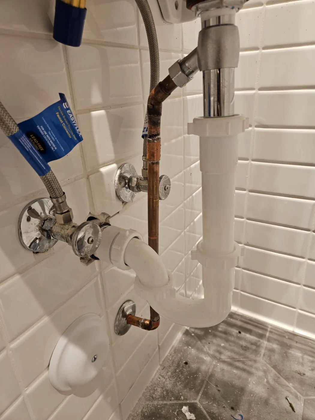 Copper supply line, shut-off valves and PVC drain trap under a sink